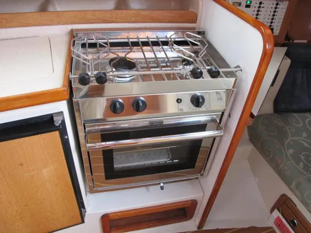 Slide: The Image of Galley area of a 2000 Catalina 310 yacht with stainless steel stove. - 9
