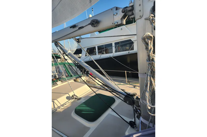 Slide: The Image of 2006 Island Packet 370 sailboat deck with rigging and ropes in marina. - 10
