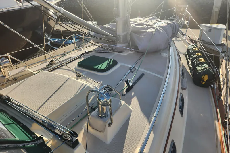 Slide: The Image of 2006 Island Packet 370 sailboat deck with rigging and equipment in sunlight. - 12