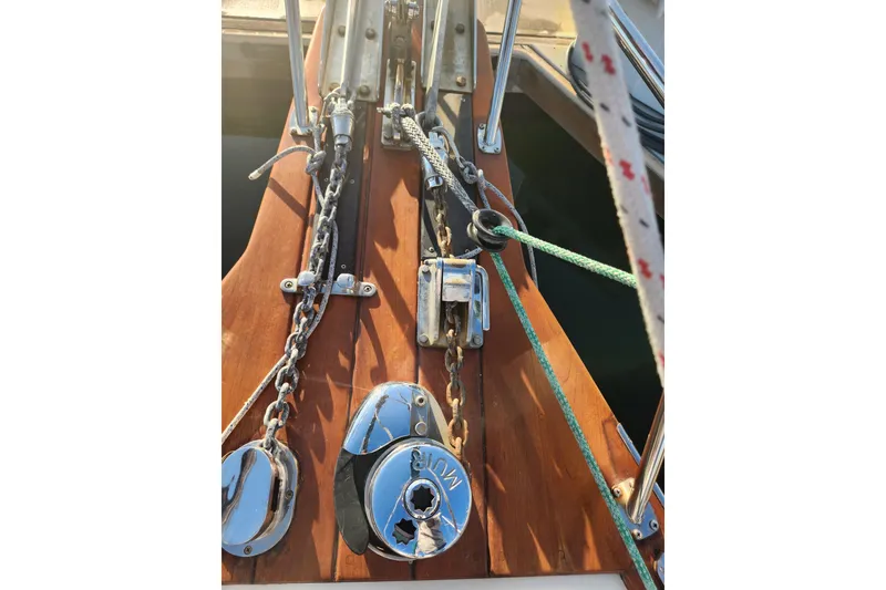 Slide: The Image of Deck hardware of a 2006 Island Packet 370 sailboat, featuring chains and ropes. - 15