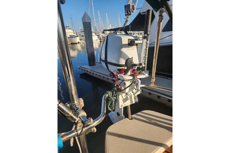 Slide: The Image of 2006 Island Packet 370 sailboat with mounted outboard motor at marina. - 16