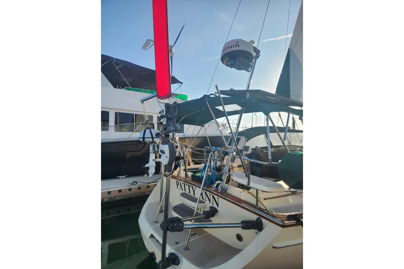 Slide: The Image of 2006 Island Packet 370 sailboat docked, featuring a wind vane and Garmin radar. - 19