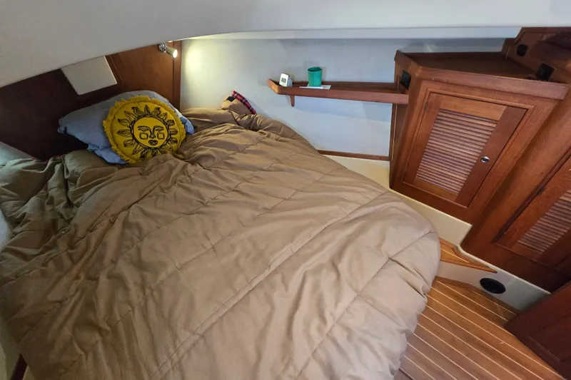 Slide: The Image of Cozy cabin interior of 2006 Island Packet 370 sailboat with sun-themed pillow. - 27