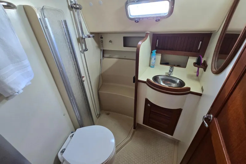 Slide: The Image of 2006 Island Packet 370 yacht bathroom with shower, sink, and toilet. - 29