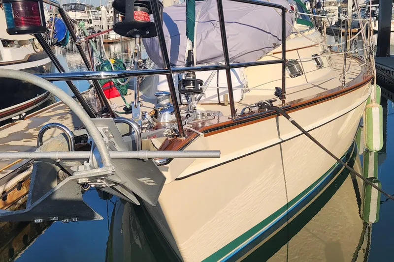 Slide: The Image of 2006 Island Packet 370 sailboat docked, showcasing deck and anchor details. - 3