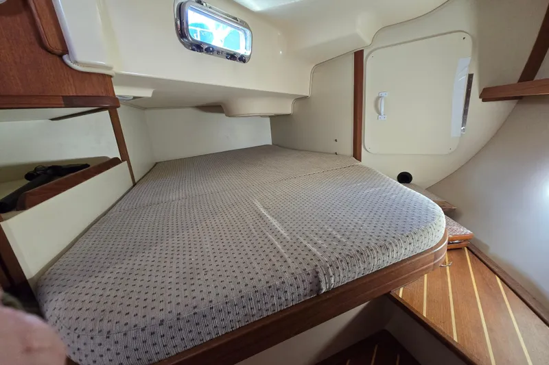 Slide: The Image of Cozy cabin interior of 2006 Island Packet 370 sailboat with comfortable bedding. - 31
