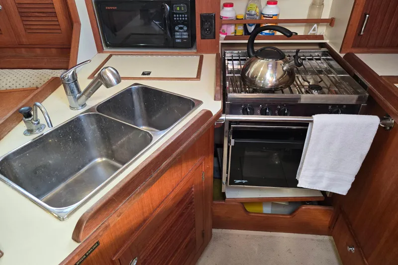 Slide: The Image of Galley kitchen in 2006 Island Packet 370 sailboat with sink, stove, and microwave. - 36