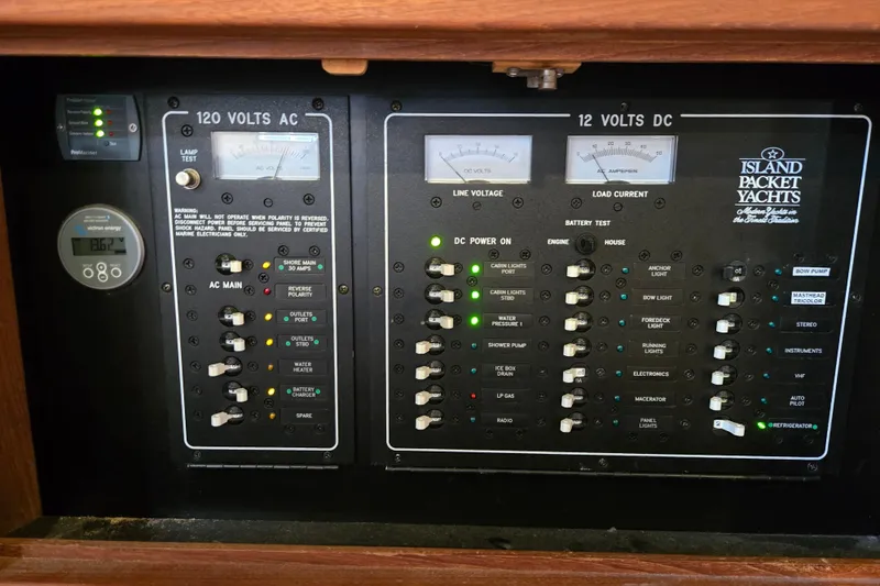 Slide: The Image of Electrical control panel of a 2006 Island Packet 370 yacht, showing AC and DC systems. - 41