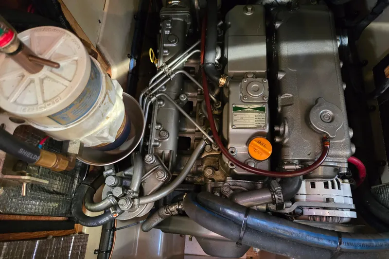 Slide: The Image of Engine compartment of a 2006 Island Packet 370 sailboat, showcasing detailed mechanical components. - 44