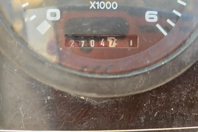 Slide: The Image of Close-up of Island Packet 370 tachometer showing 2704.7 hours, model year 2006. - 56