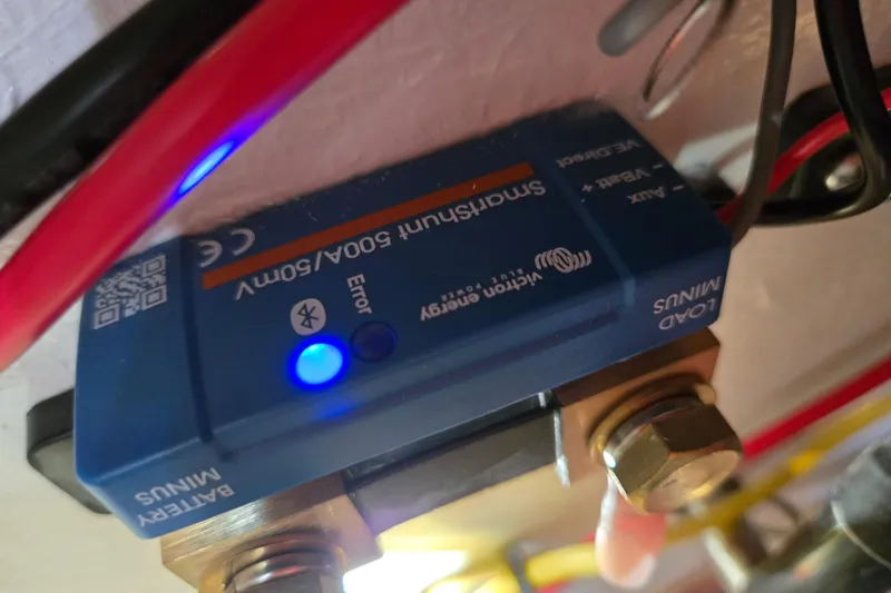 Slide: The Image of Victron Energy SmartShunt 500A/50mV with blue LED indicator on Island Packet 370, 2006 model. - 58