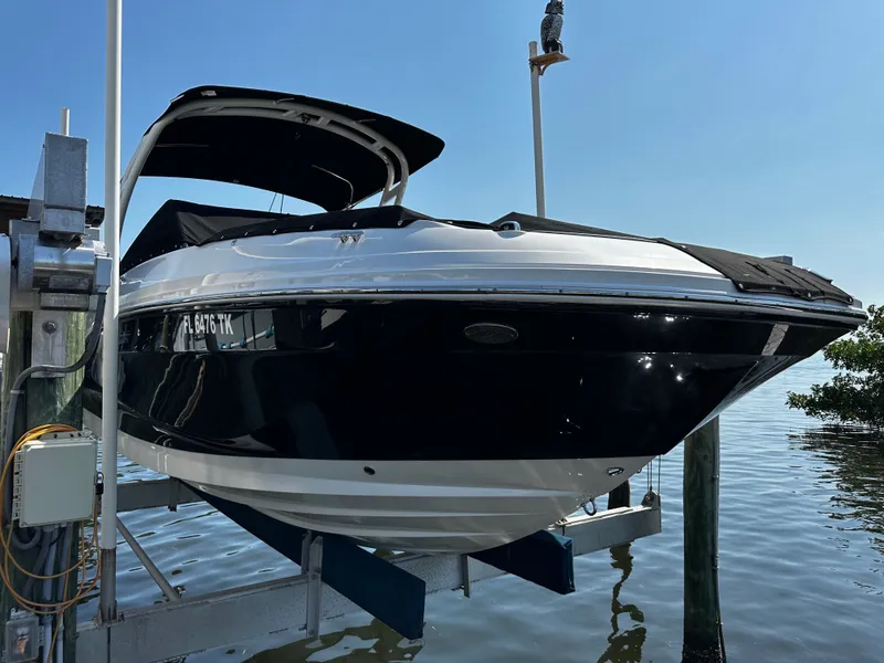 Slide: The Image of 2023 Sea Ray SDX 250 Outboard on boat lift by water. - 3