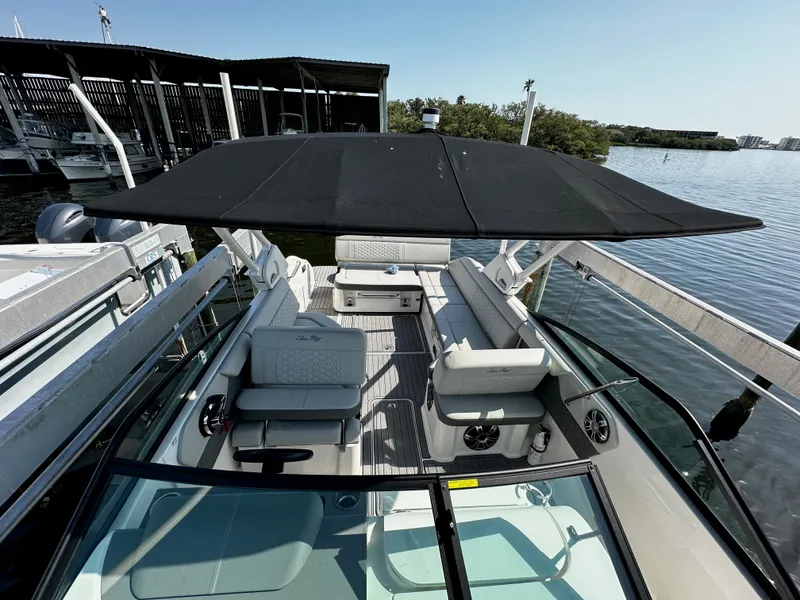Slide: The Image of 2023 Sea Ray SDX 250 Outboard with black sunshade at dock. - 30