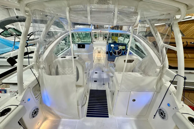 Slide: The Image of 2024 Pursuit DC 266 Dual Console boat interior with modern seating and steering area. - 10