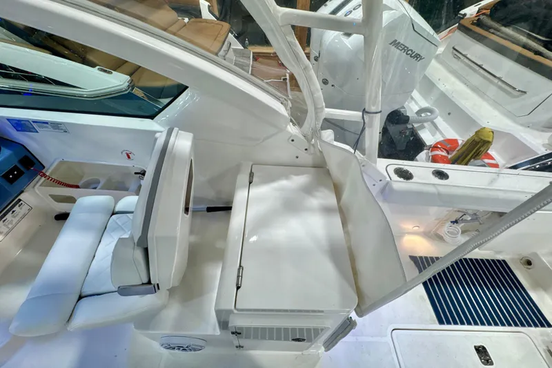 Slide: The Image of 2024 Pursuit DC 266 Dual Console boat interior with seating and Mercury engine. - 11