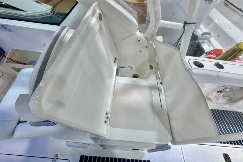 Slide: The Image of 2024 Pursuit DC 266 Dual Console boat interior with foldable seating and storage. - 12