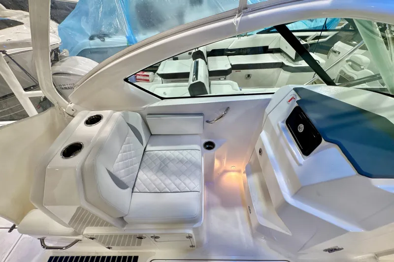 Slide: The Image of 2024 Pursuit DC 266 Dual Console interior with white seating and modern dashboard. - 14