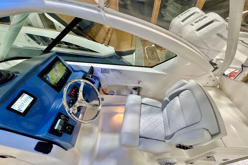 Slide: The Image of 2024 Pursuit DC 266 Dual Console boat interior with modern dashboard and comfortable seating. - 15