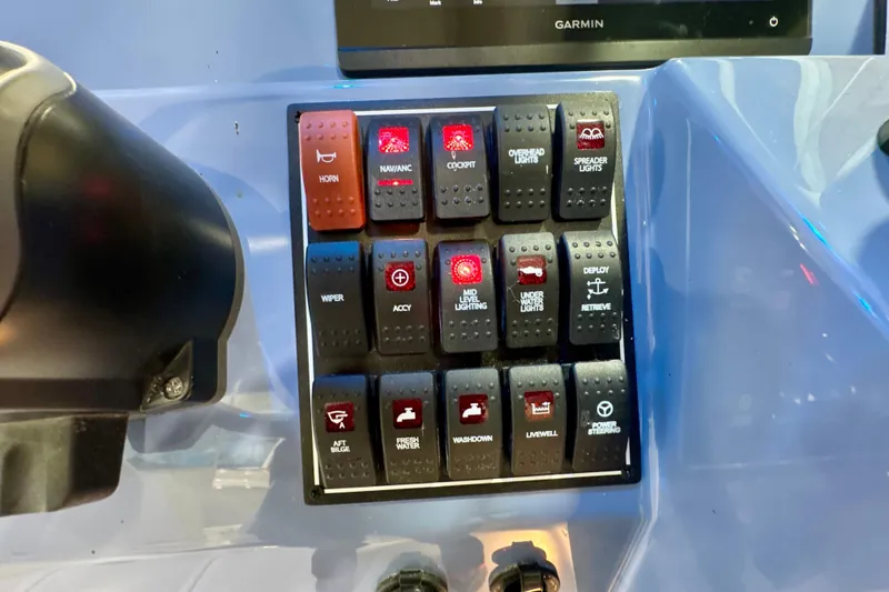 Slide: The Image of Control panel of 2024 Pursuit DC 266 Dual Console boat with labeled switches. - 18