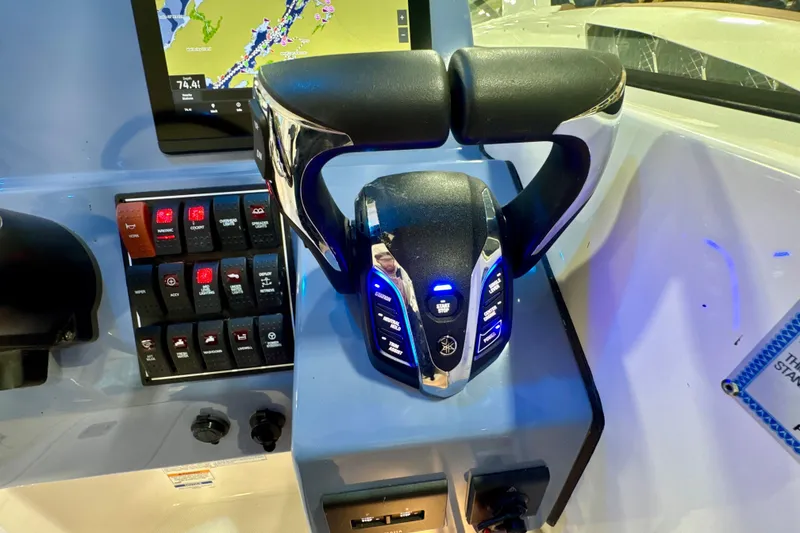 Slide: The Image of 2024 Pursuit DC 266 Dual Console boat dashboard with controls and navigation display. - 20