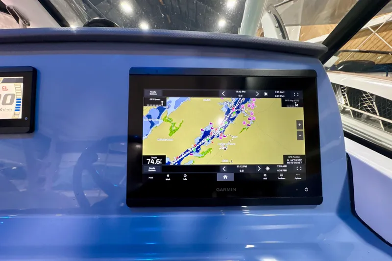 Slide: The Image of 2024 Pursuit DC 266 Dual Console with Garmin navigation display showing nautical map. - 21