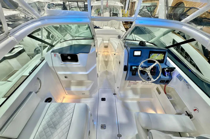 Slide: The Image of 2024 Pursuit DC 266 Dual Console boat interior with modern dashboard and seating. - 22
