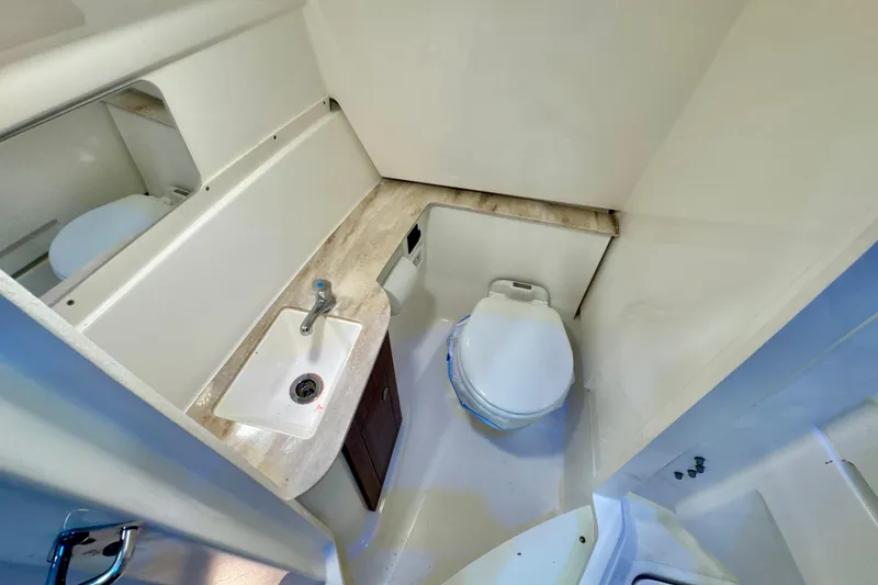 Slide: The Image of 2024 Pursuit DC 266 Dual Console boat bathroom with sink and toilet. - 23