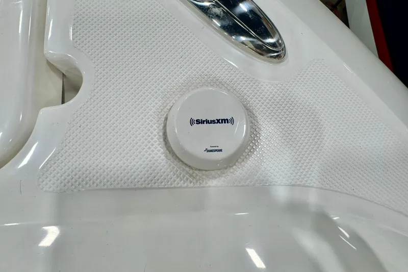 Slide: The Image of SiriusXM antenna on 2024 Pursuit DC 266 Dual Console boat, featuring textured white surface. - 29