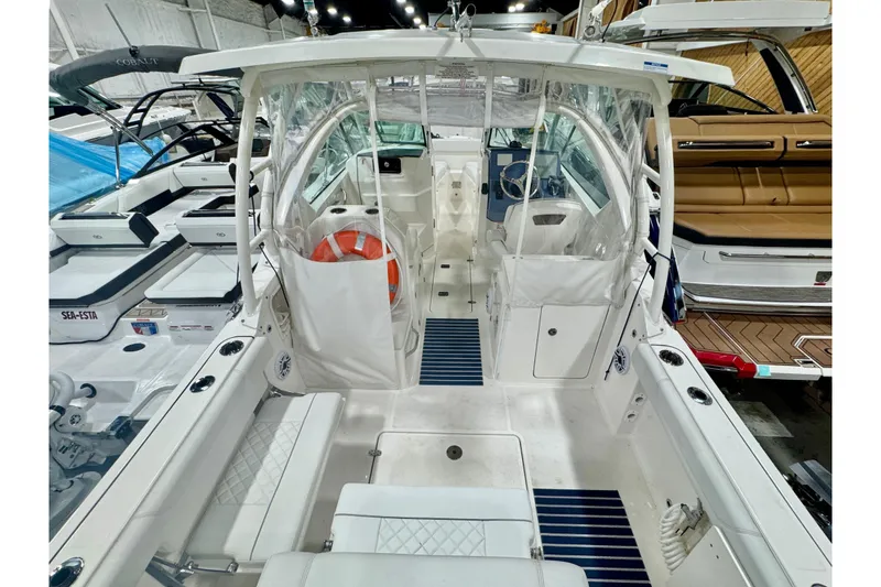 Slide: The Image of 2024 Pursuit DC 266 Dual Console boat interior with seating and steering area. - 3