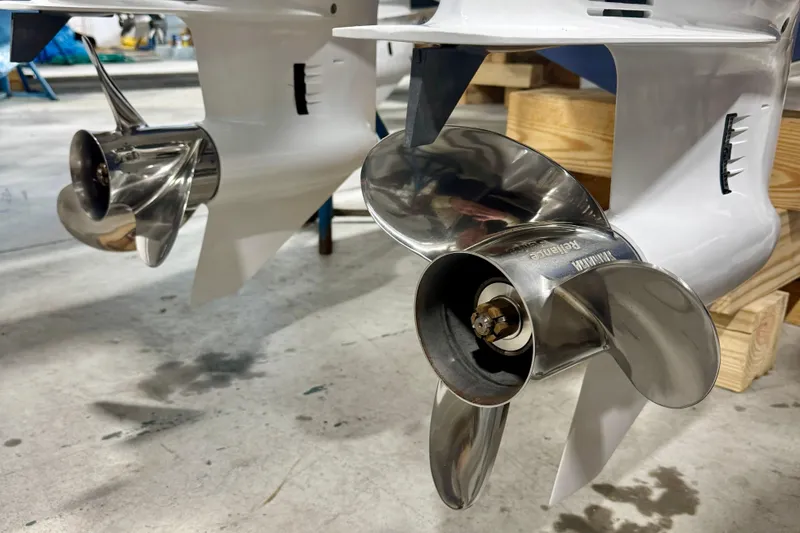 Slide: The Image of 2024 Pursuit DC 266 Dual Console boat propellers in a workshop setting. - 30