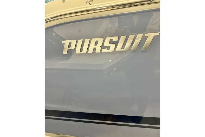 Slide: The Image of 2024 Pursuit DC 266 Dual Console boat logo on sleek exterior. - 31