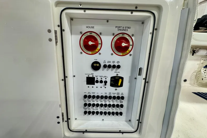 Slide: The Image of Electrical panel of 2024 Pursuit DC 266 Dual Console boat, featuring switches and controls. - 33