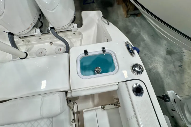 Slide: The Image of 2024 Pursuit DC 266 Dual Console boat interior with livewell and seating area. - 9