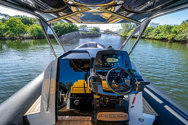 Slide: The Image of 2025 SACS Strider 11 luxury yacht cockpit with advanced navigation system on a scenic waterway. - 13