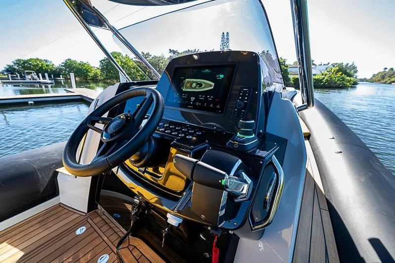 Slide: The Image of 2025 SACS Strider 11 boat cockpit with modern steering and navigation system. - 14