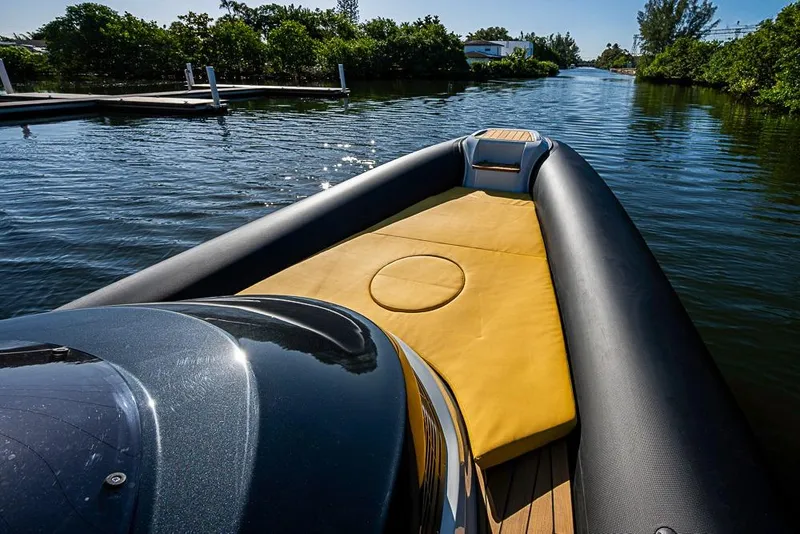 Slide: The Image of 2025 SACS Strider 11 luxury boat with yellow seating, cruising on a serene waterway. - 20