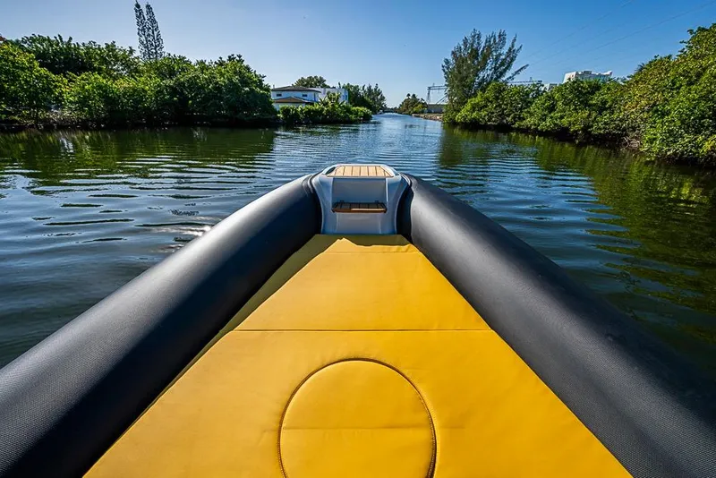 Slide: The Image of 2025 SACS Strider 11 boat cruising on a scenic river with lush greenery. - 21