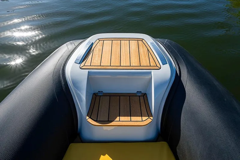 Slide: The Image of 2025 SACS Strider 11 boat with sleek deck design on calm water. - 22