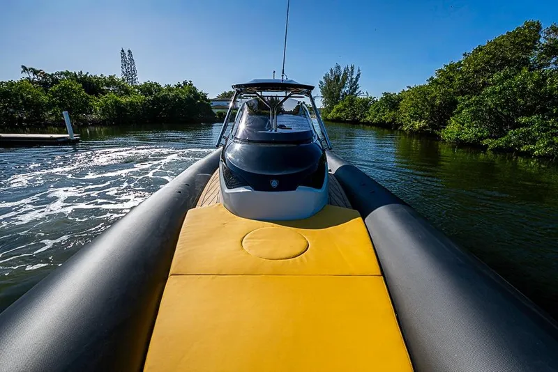 Slide: The Image of 2025 SACS Strider 11 boat cruising on a sunny day, featuring a sleek design. - 23