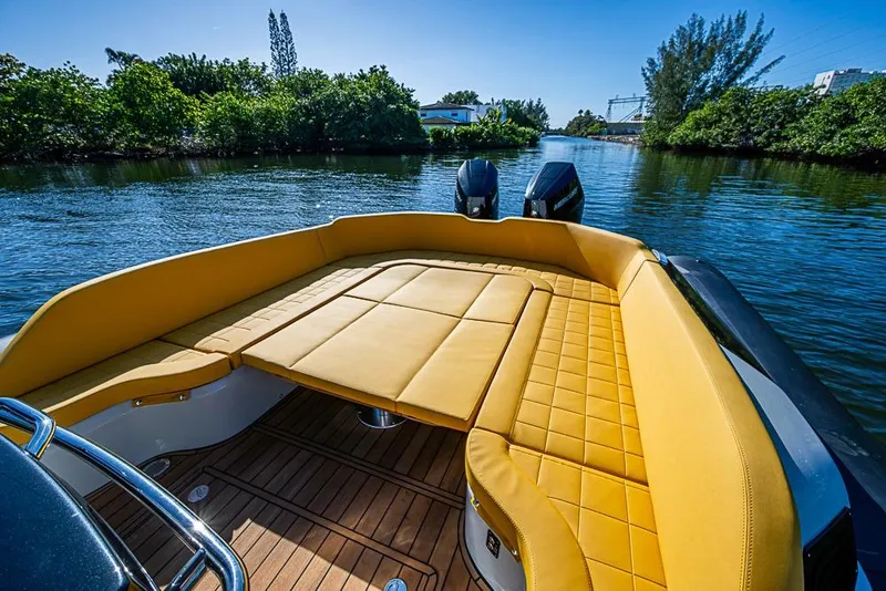 Slide: The Image of 2025 SACS Strider 11 boat with luxurious yellow seating on a serene waterway. - 27