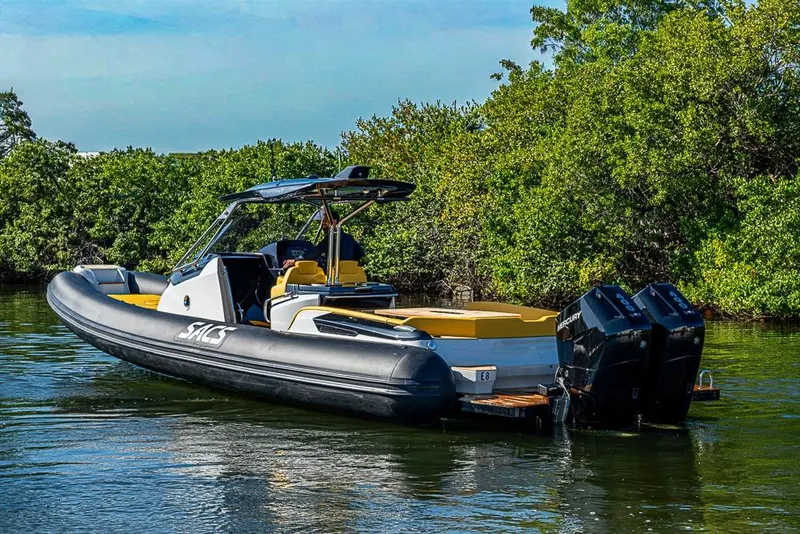 Slide: The Image of 2025 SACS Strider 11 boat with dual engines on a serene waterway. - 3