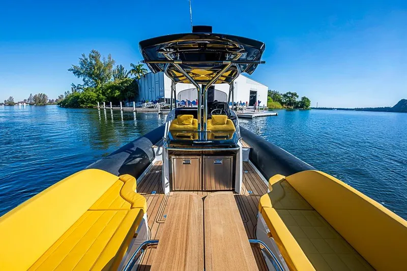 Slide: The Image of 2025 SACS Strider 11 boat with yellow seating, docked on a sunny day. - 30