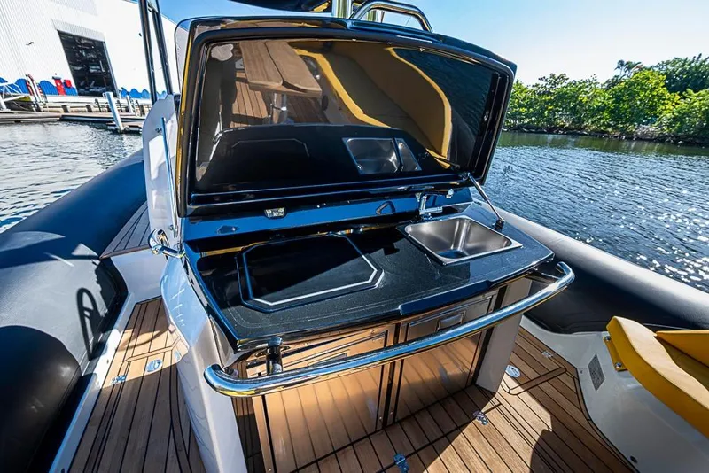 Slide: The Image of 2025 SACS Strider 11 yacht with sleek outdoor kitchen and scenic water view. - 31