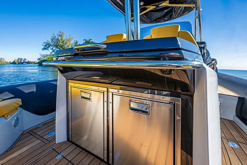 Slide: The Image of 2025 SACS Strider 11 yacht interior with stainless steel appliances and luxurious seating. - 32