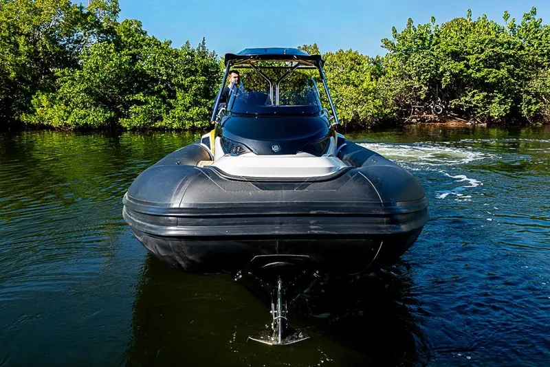 Slide: The Image of 2025 SACS Strider 11 navigating through calm waters, surrounded by lush greenery. - 5