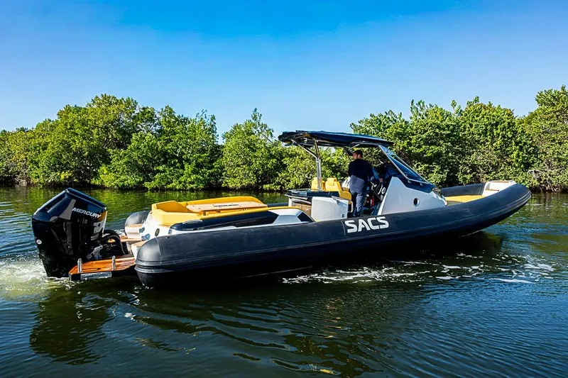 Slide: The Image of 2025 SACS Strider 11 boat cruising on a calm waterway, surrounded by lush greenery. - 8