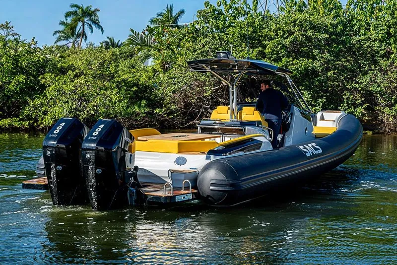 Slide: The Image of 2025 SACS Strider 11 boat with dual engines cruising on a scenic waterway. - 9