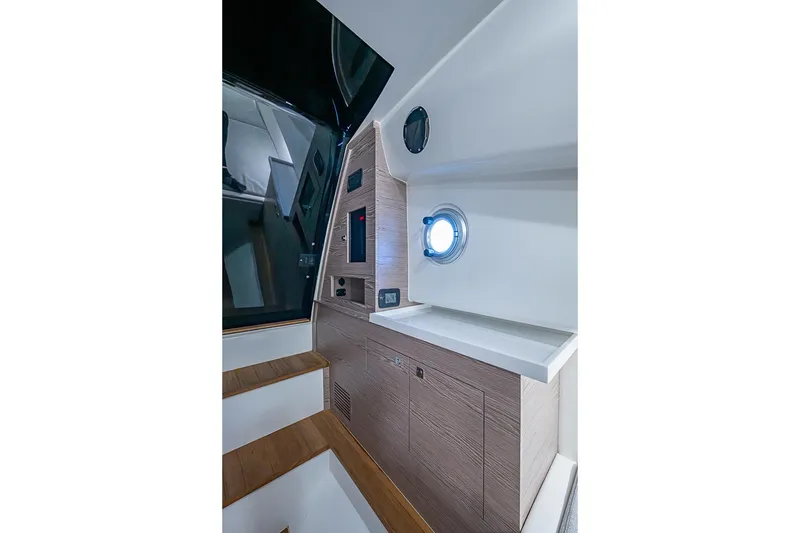 Slide: The Image of Interior of 2025 SACS Strider 11 yacht, featuring modern design and porthole window. - 36