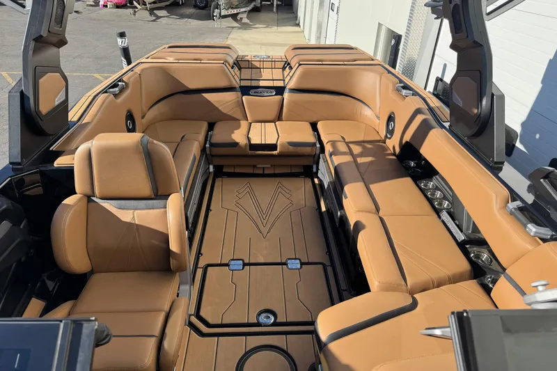 Slide: The Image of 2024 Supra SL 575 boat interior with luxurious tan seating and modern design. - 10