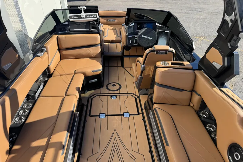 Slide: The Image of 2024 Supra SL 575 boat interior with luxurious tan seating and modern dashboard. - 6